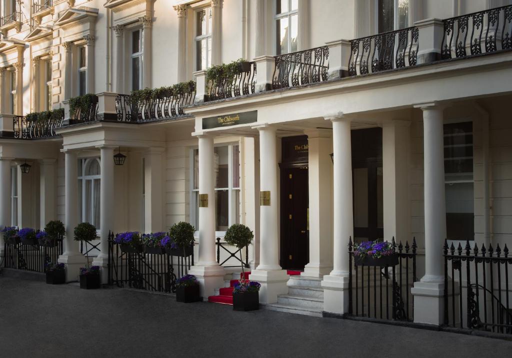 een wit gebouw met witte zuilen en potplanten bij Montcalm Chilworth Townhouse, Paddington in Londen