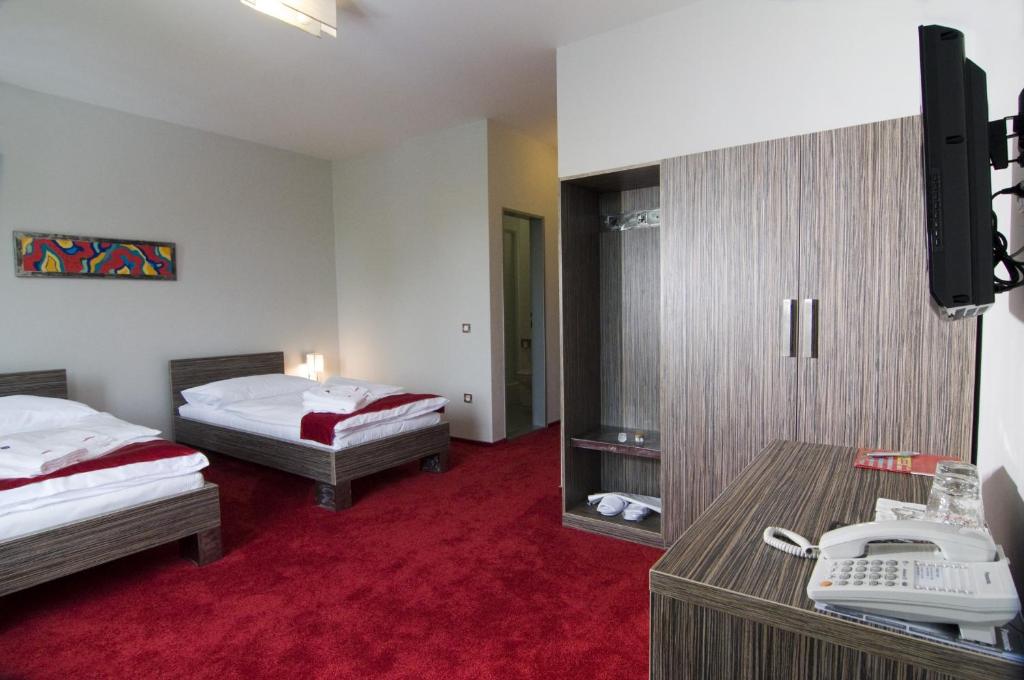 Postel nebo postele na pokoji v ubytování Hotel Olympia