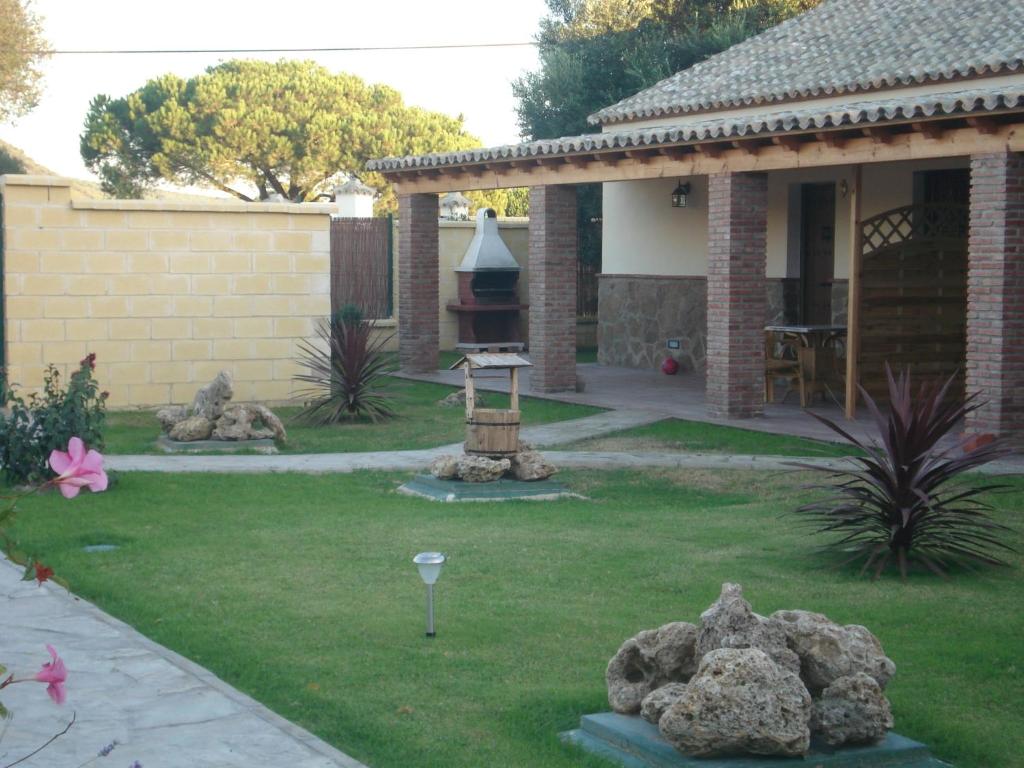 a yard with rocks in front of a house at Residencial La Teja in Zahora