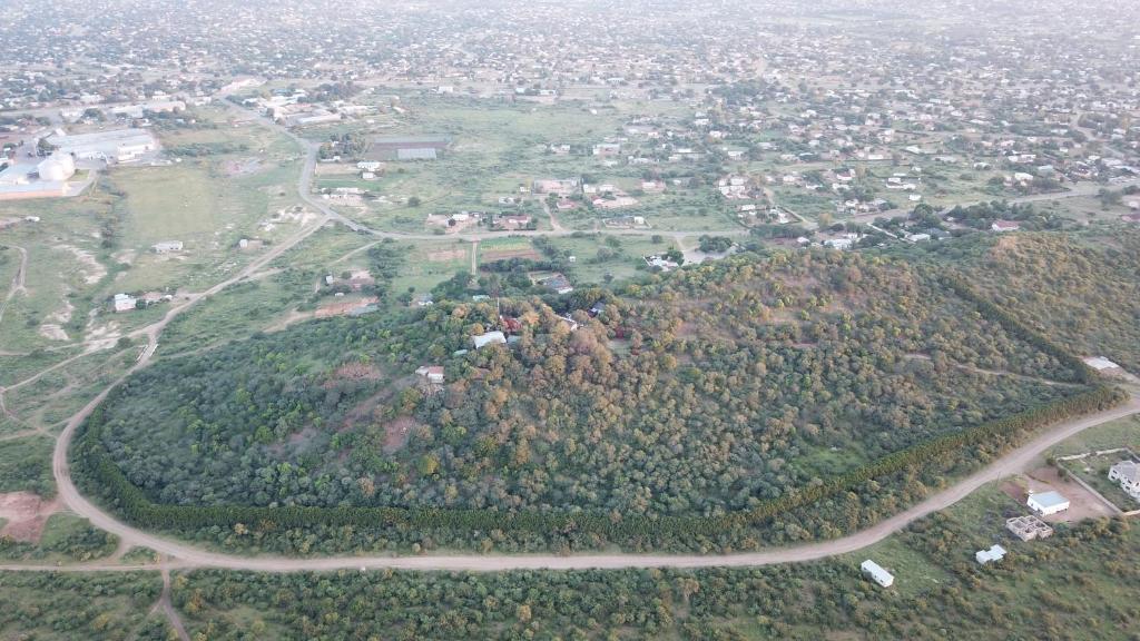 an aerial view of a town on a hill with trees at Lentswe Lodge in Serowe