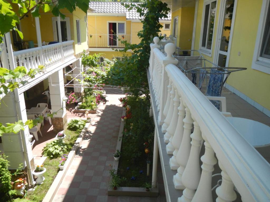 a balcony of a house with flowers and plants at Hotel Lev in Zatoka