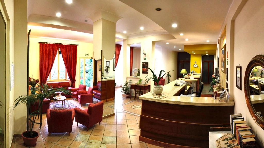a large room with a large couch and a large mirror at Hotel Mediterraneo in Cefalù