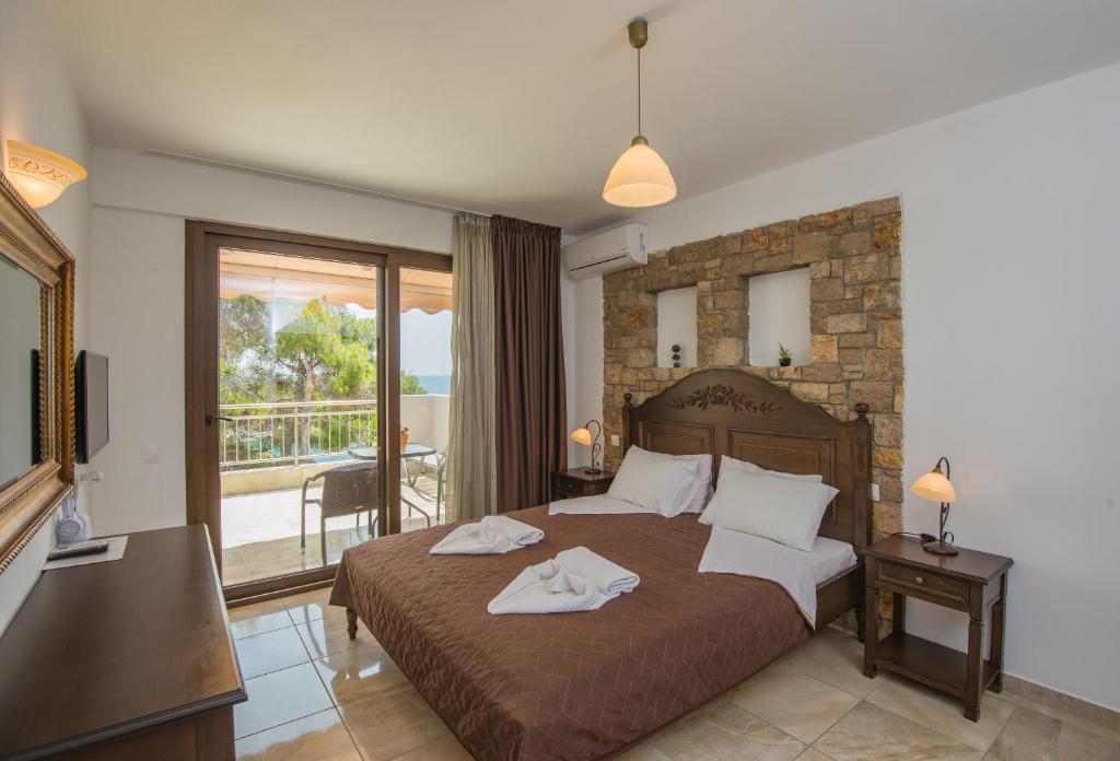 Postel nebo postele na pokoji v ubytování Marilena Apartments