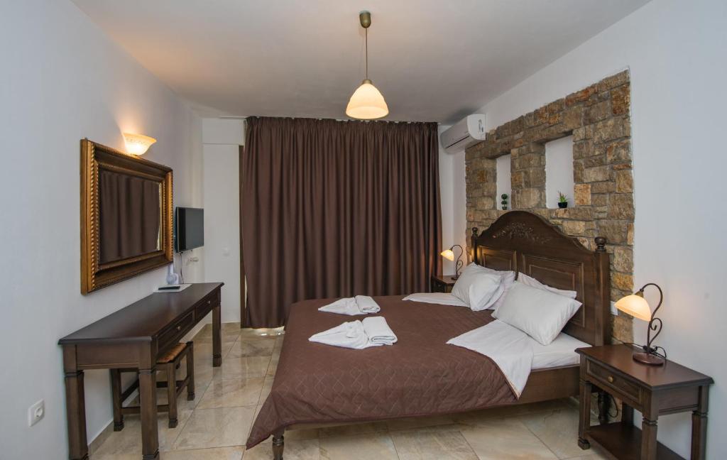 Postel nebo postele na pokoji v ubytování Marilena Apartments