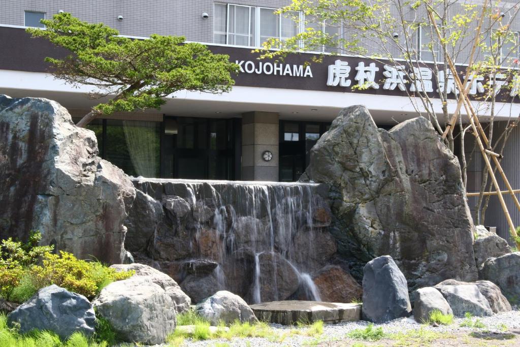 una cascada frente a un edificio en Kojohama Onsen Hotel, en Shiraoi