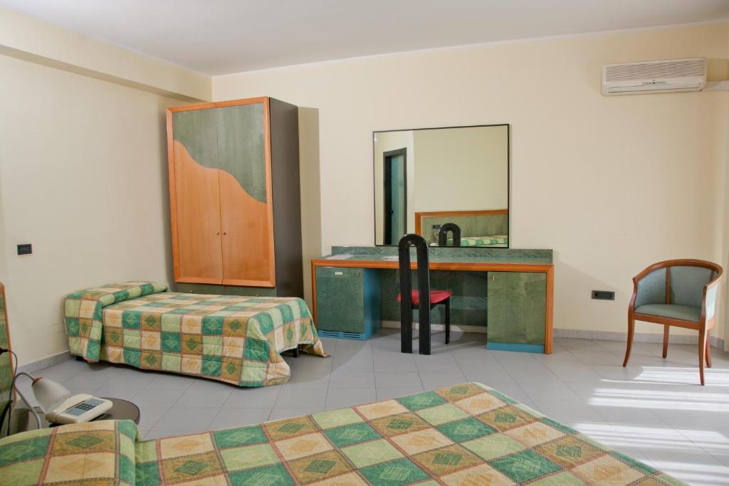 Postel nebo postele na pokoji v ubytování Hotel Melissa