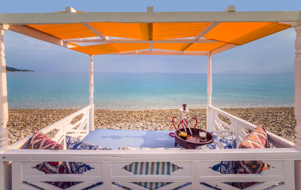 a porch with a view of the beach at Kokkari Beach Hotel in Kokkari
