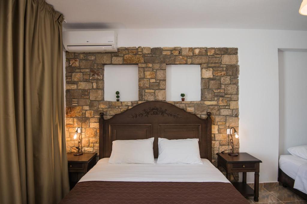 Postel nebo postele na pokoji v ubytování Marilena Apartments