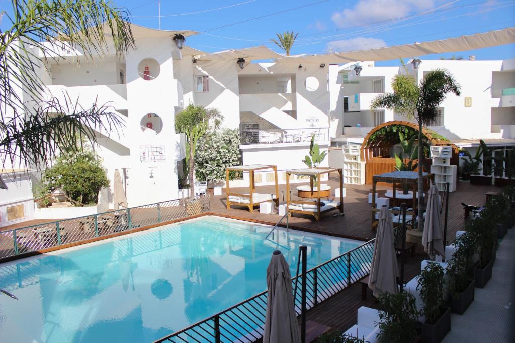 a swimming pool in front of a building at Apartamentos Bora Bora - Adults Only in Playa d'en Bossa