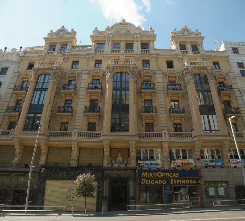 a large building on the corner of a street at Hostal La Selecta in Madrid