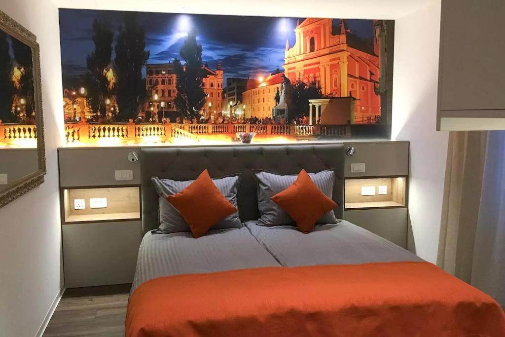 a bedroom with a bed with a picture on the wall at ★ Exclusive Central Apartment ★ FREE Garage ★ in Ljubljana