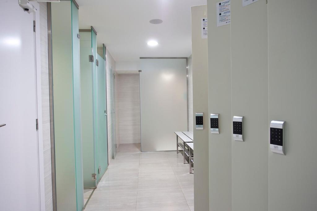a hallway of a hospital with green and white walls at Hotel Torre del Mar - Ibiza in Playa d'en Bossa