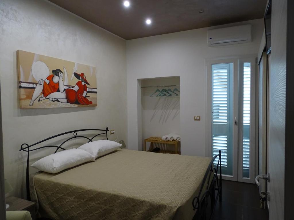 a bedroom with a bed in a room at Nonna Ia B&B in Parabita