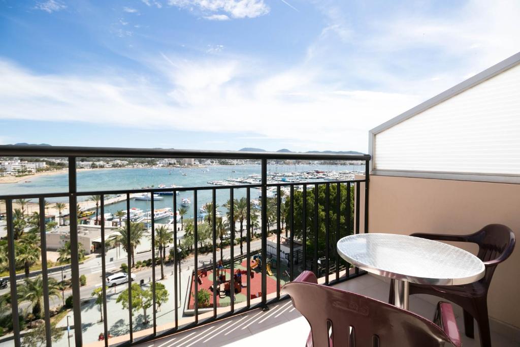 a balcony overlooking a beach with a view of the ocean at The Red Hotel - Adults Only in San Antonio