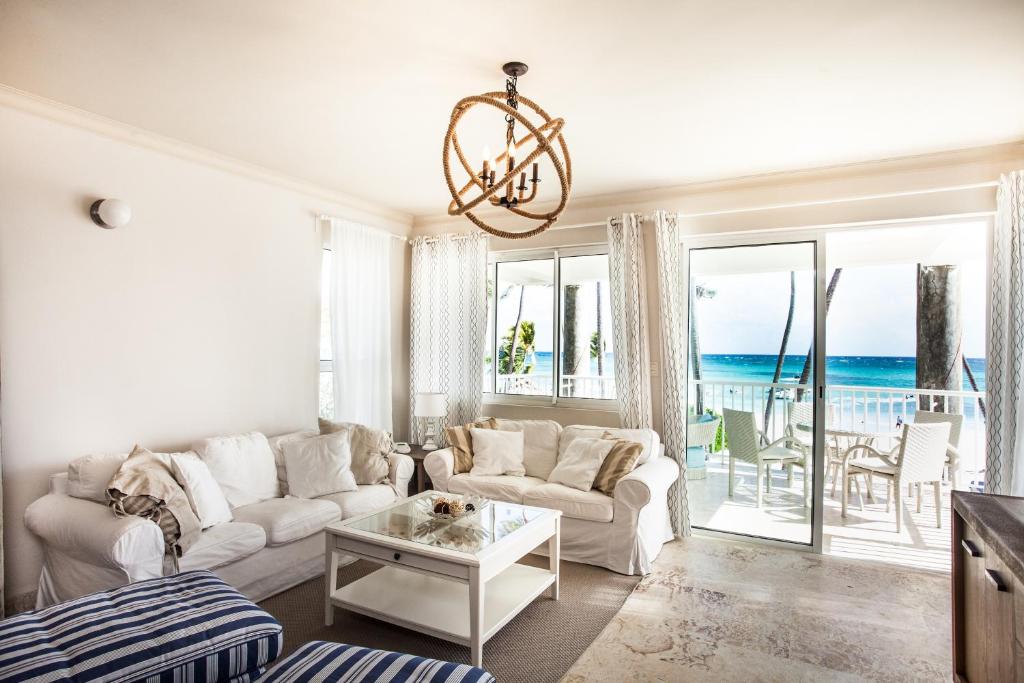 Playa Turquesa Ocean Club في بونتا كانا: غرفة معيشة مع أريكة وطاولة