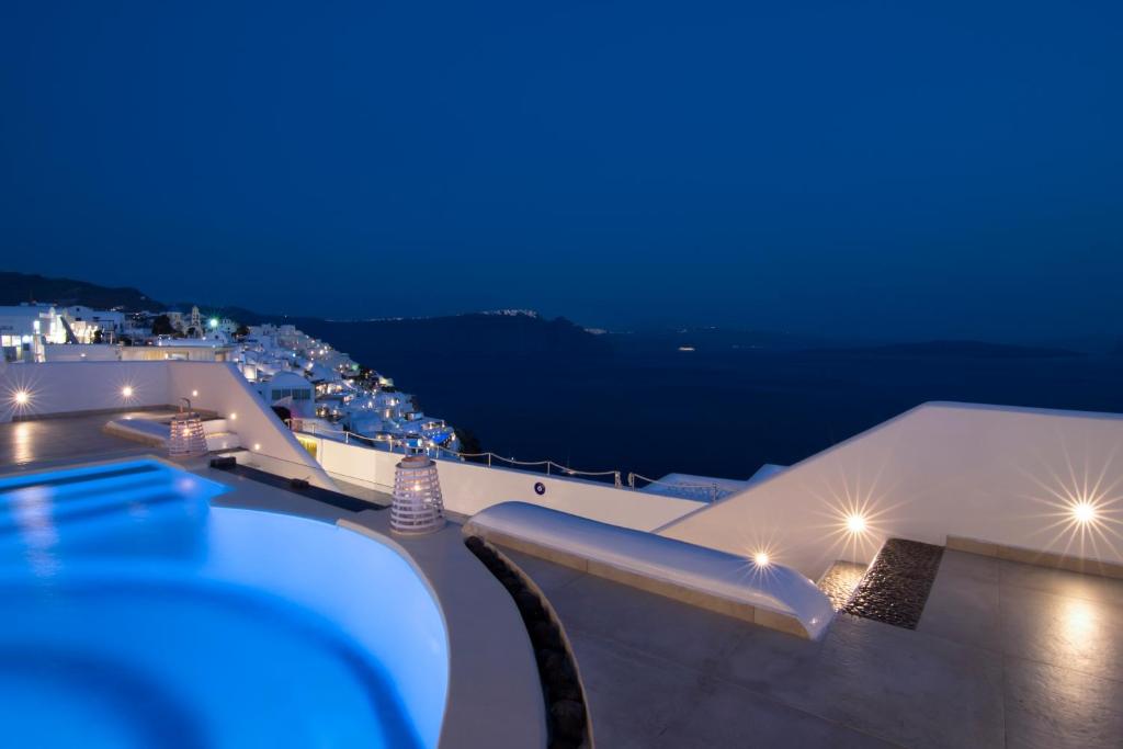 a view of a rooftop of a building at night at Santorini Secret Premium in Oia