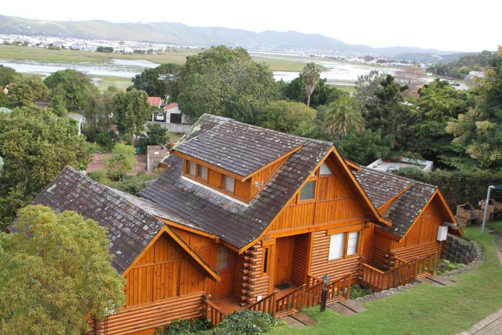 a wooden house with a roof at Abalone Lodges in Knysna