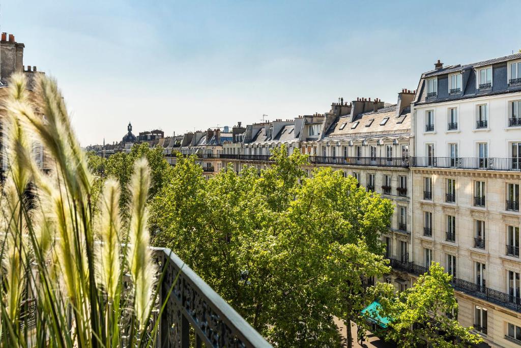 a view of a city with buildings and trees at Hotel Marais Grands Boulevards in Paris