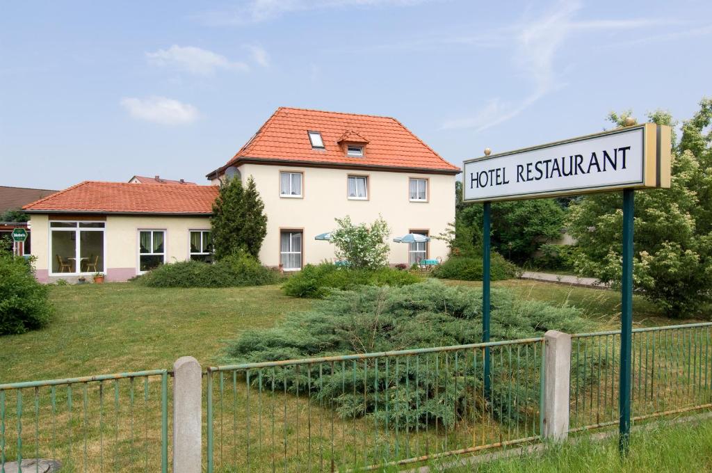 a sign for a road in front of a house at Hotel Heidler in Niederau