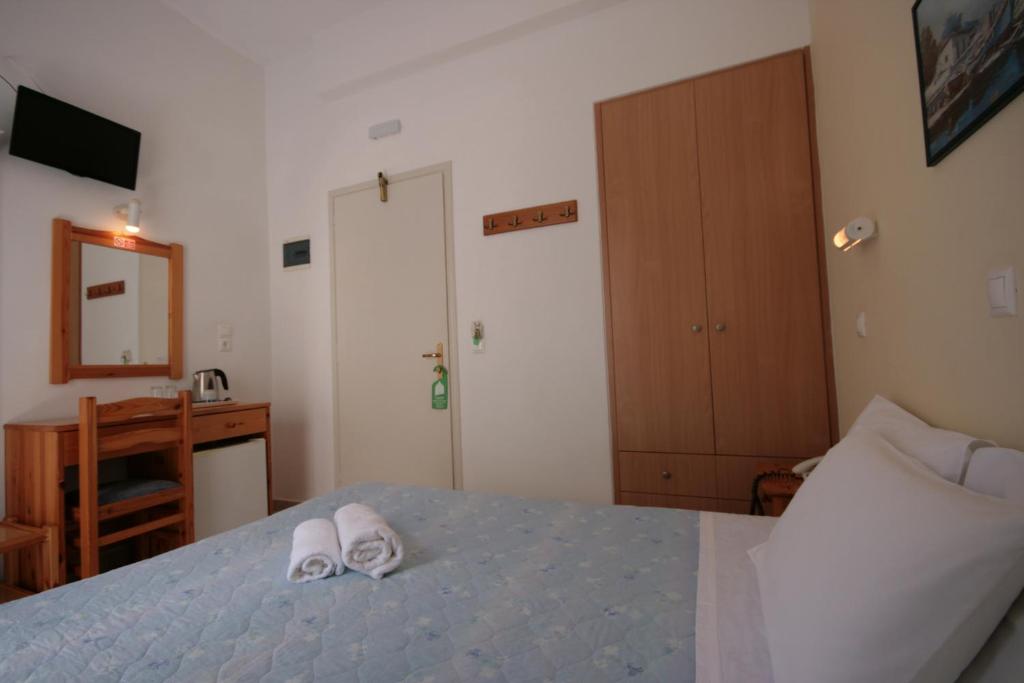 Postel nebo postele na pokoji v ubytování Hotel Zeus