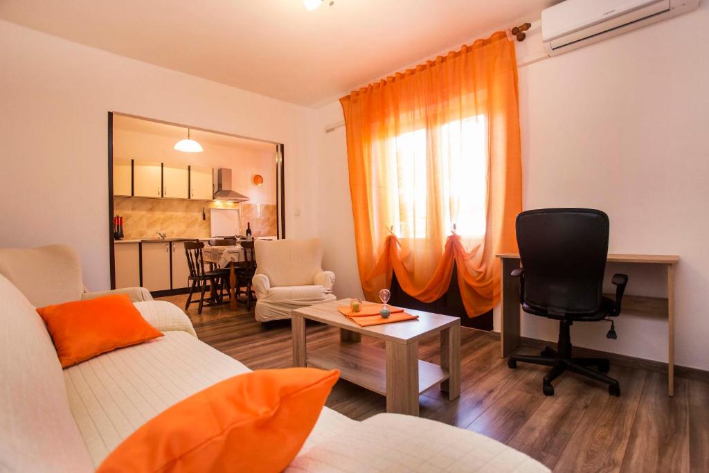 a living room with a couch and a table at Elena Apartment- Spacious for 6, 2 Bathrooms, Free Parking in Rovinj