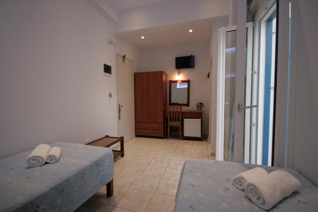 Postel nebo postele na pokoji v ubytování Hotel Zeus