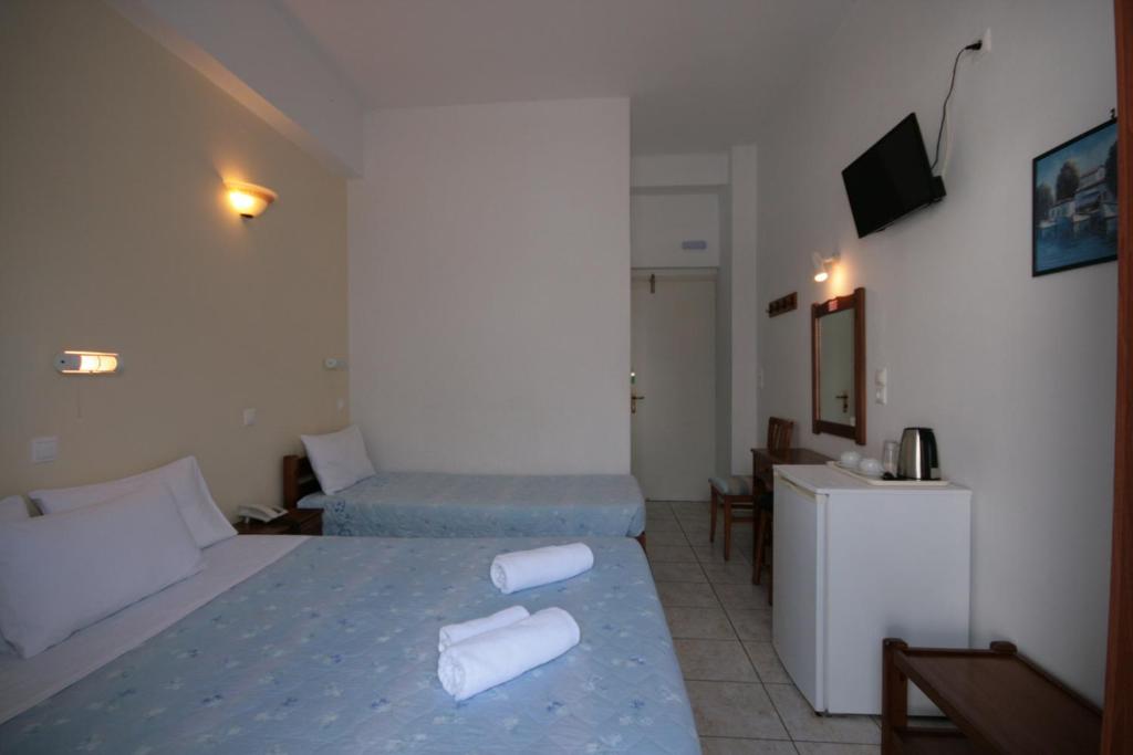 Postel nebo postele na pokoji v ubytování Hotel Zeus