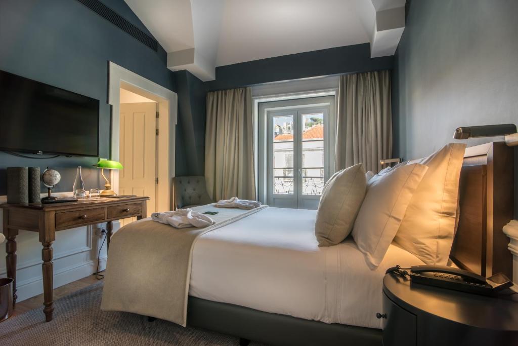 Postel nebo postele na pokoji v ubytování Hotel da Baixa