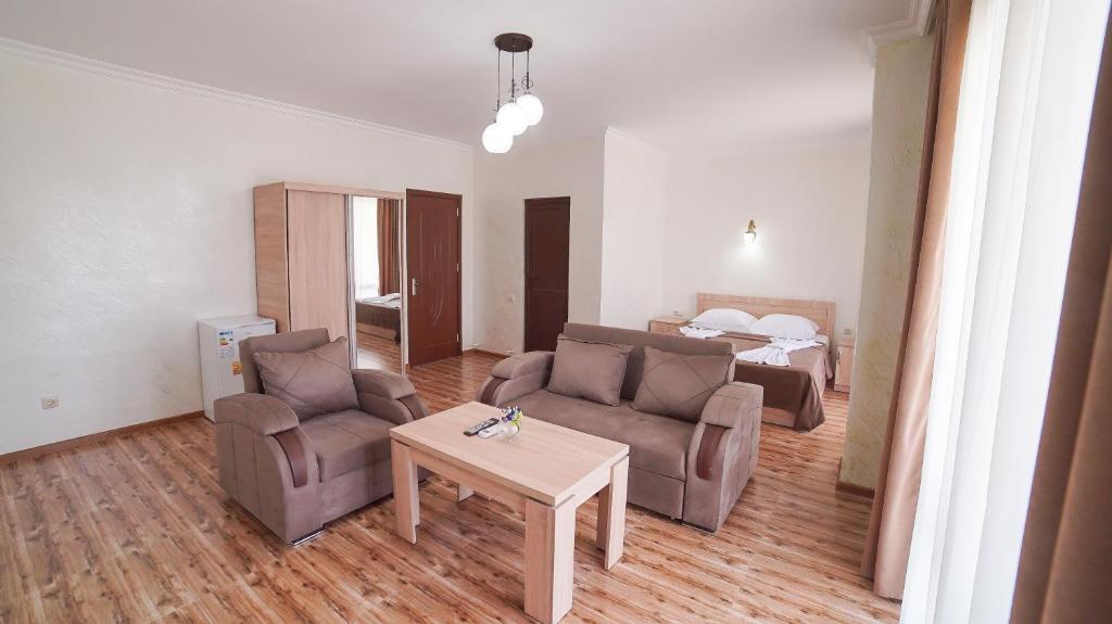 a living room with a couch and a table at Hotel Chakvi in Chakvi