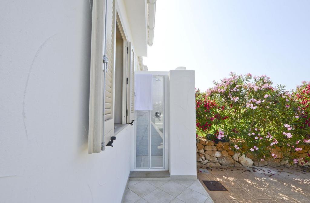 an open door of a white building with a window at Blue Sea Villas by Wonderful Italy in Ostuni