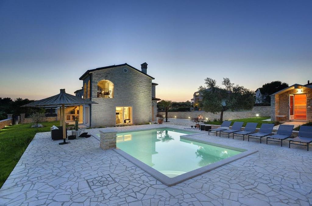a swimming pool in front of a house at Villa Paradiso in Rovinj