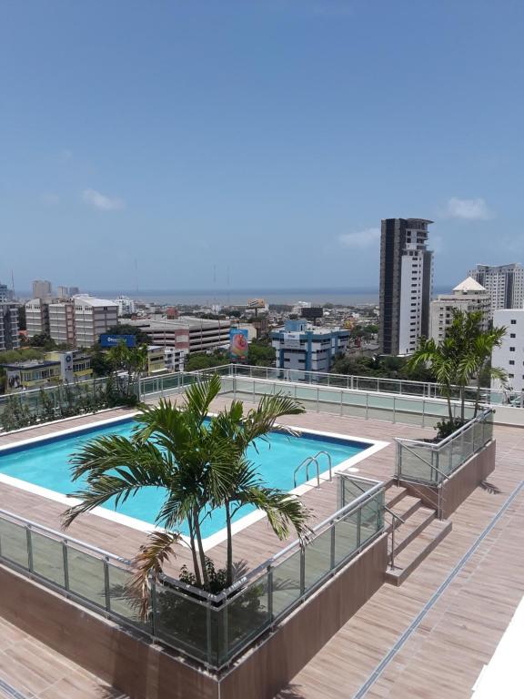 a swimming pool on the roof of a building at Villa Palmera XVIII in Santo Domingo