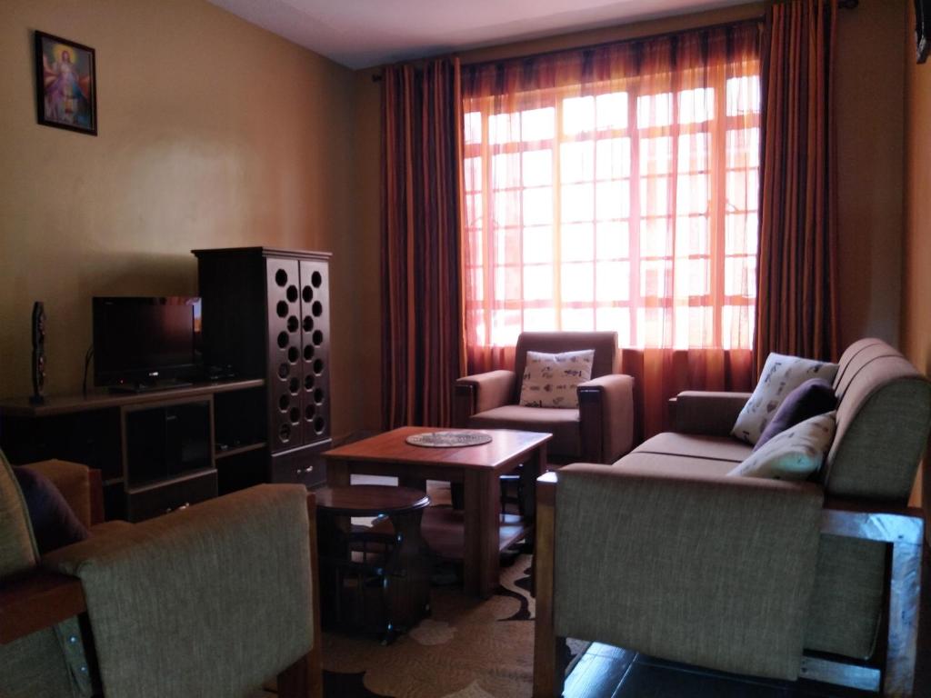 a living room with a couch and a table at Annie's House in Syokimau