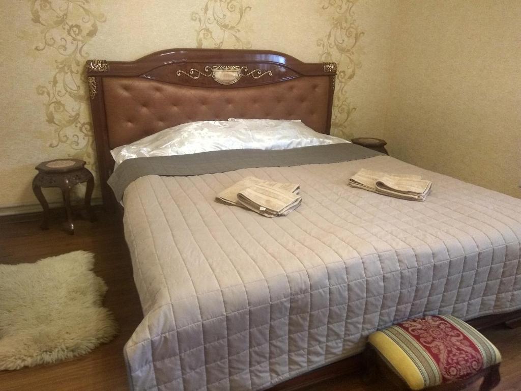 a bedroom with a bed with two towels on it at Hotel Andreevsky in Vinnytsya