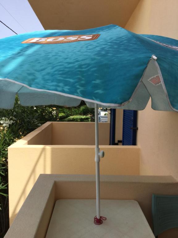 a blue umbrella sitting on top of a box at Eugenia travasarou sea view appartments in Diakofti