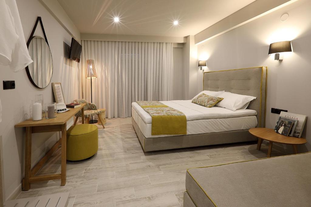 a hotel room with a bed and a desk at Kallini Apartments in Stavros