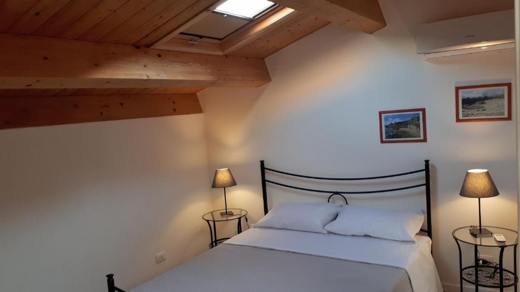 een slaapkamer met een bed en twee lampen op tafels bij Eleven in Siracusa