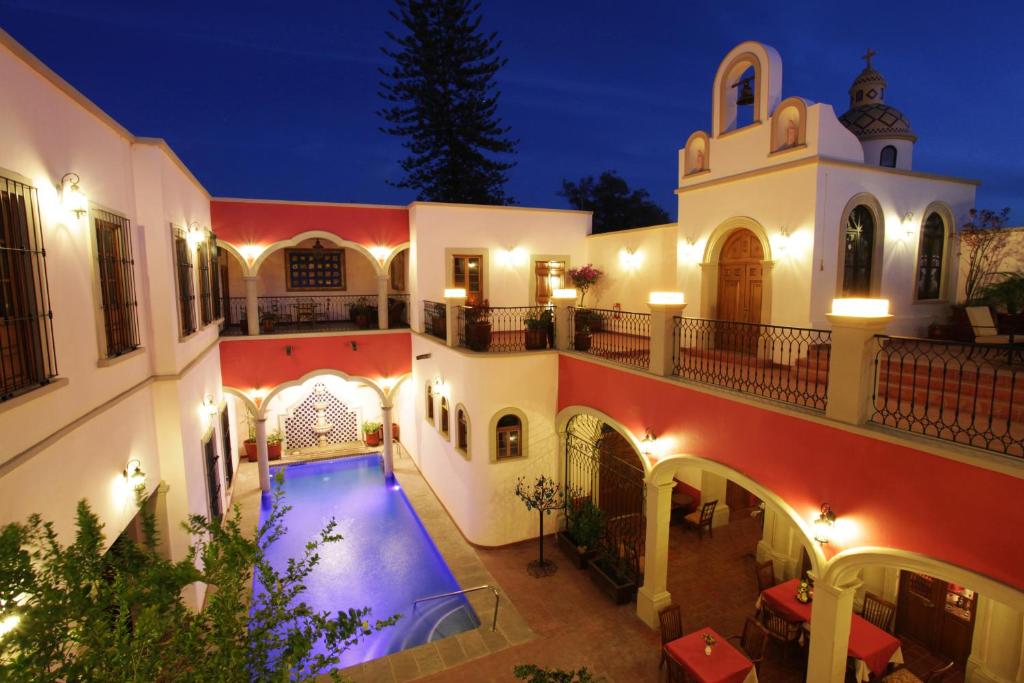 an external view of a house with a swimming pool at Gran Casa Sayula Galeria & SPA in Sayula