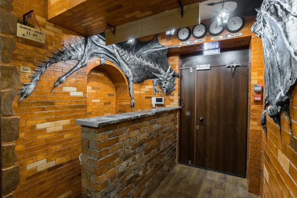 a wall with a dragon mural next to a door at Winterfell Paveletskaya in Moscow