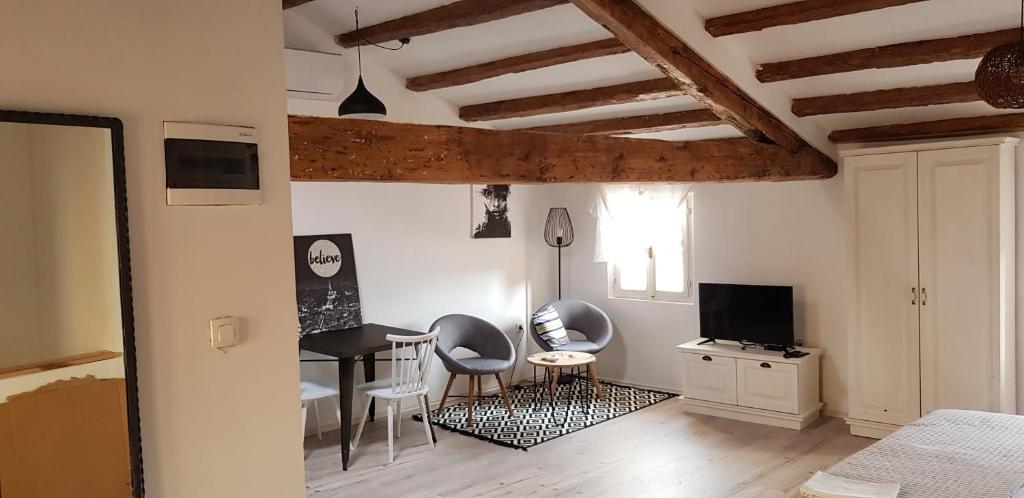 a living room with a table and chairs and a bedroom at Casa Mulino in Rovinj