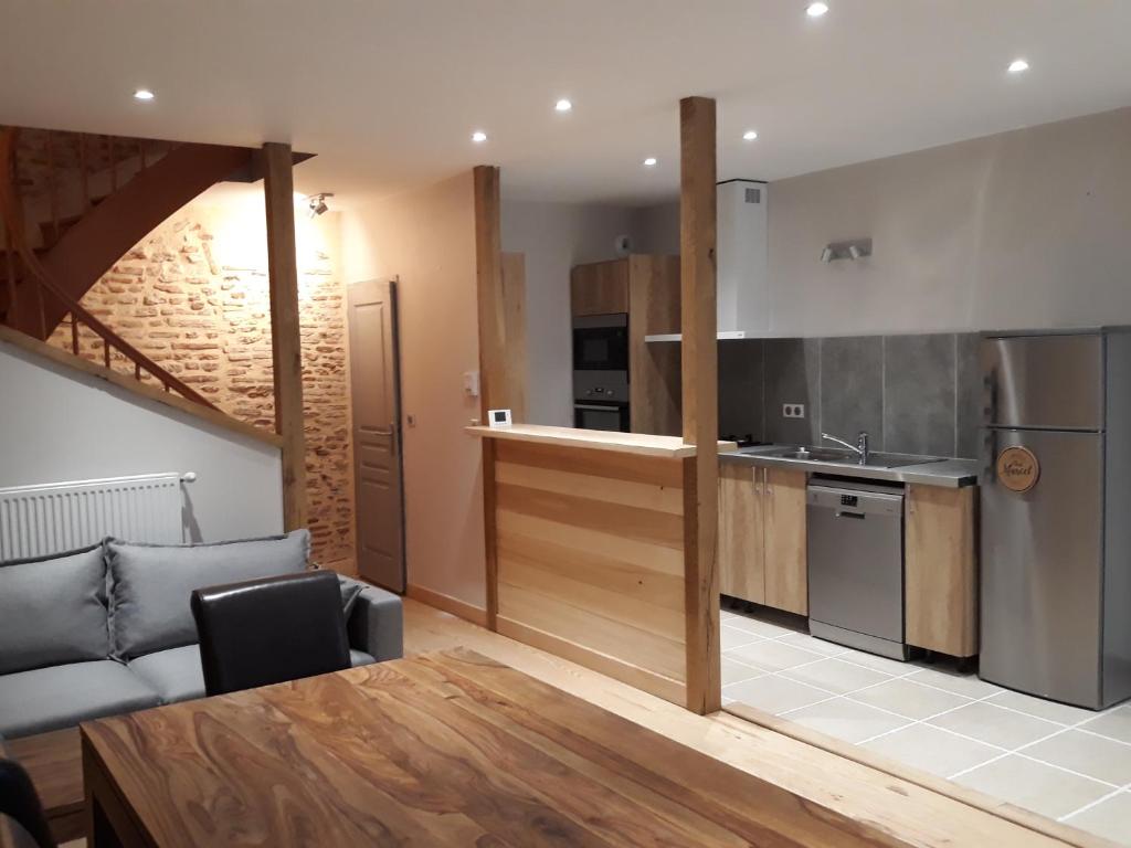 eine Küche und ein Esszimmer mit einem Tisch und einem Sofa in der Unterkunft Gite d'Emilie - Cahors Centre Ville avec Garage - 3 étoiles in Cahors