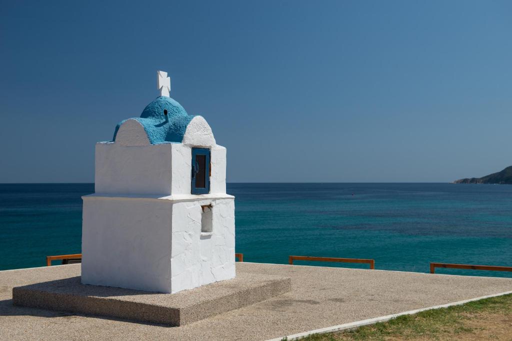 a small white building on the side of the ocean at House Katerina Mediterranean in Sarti
