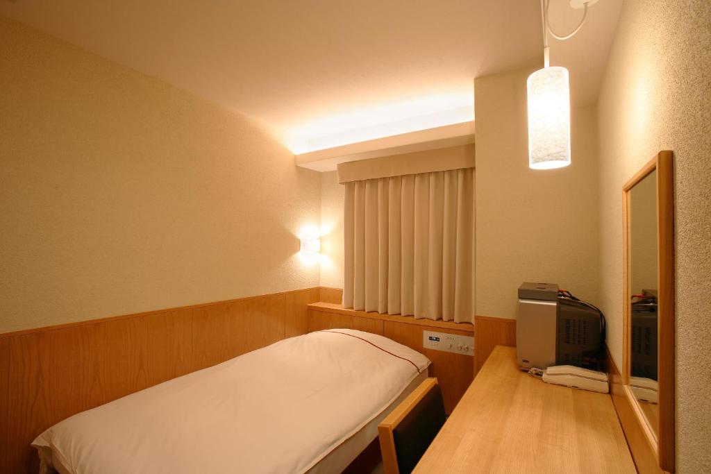 Postel nebo postele na pokoji v ubytování Okayama View Hotel
