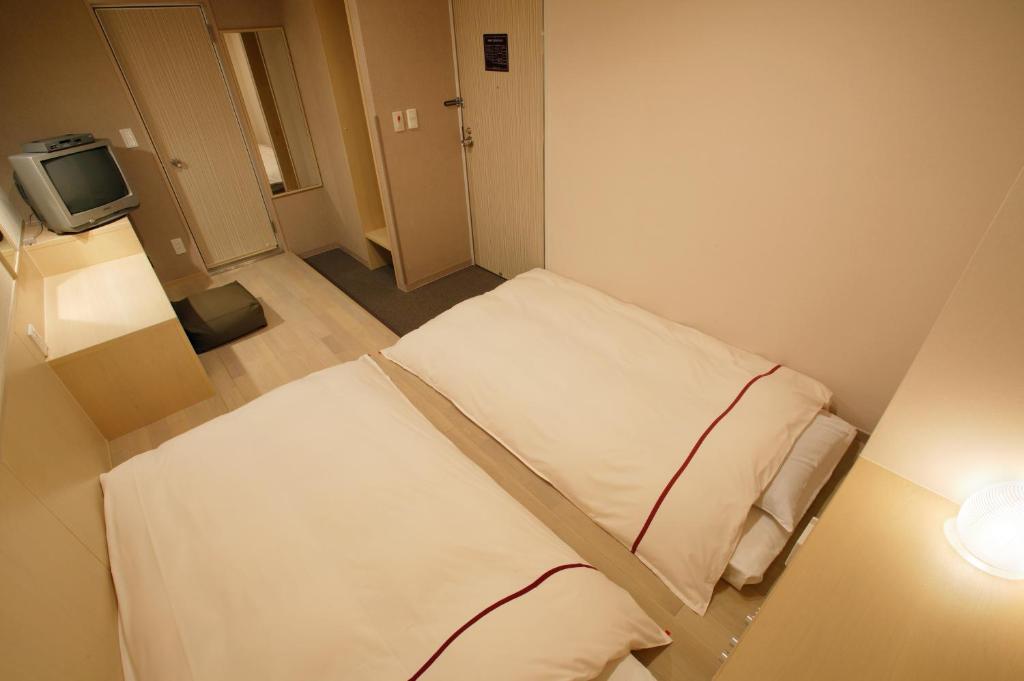 Postel nebo postele na pokoji v ubytování Okayama View Hotel