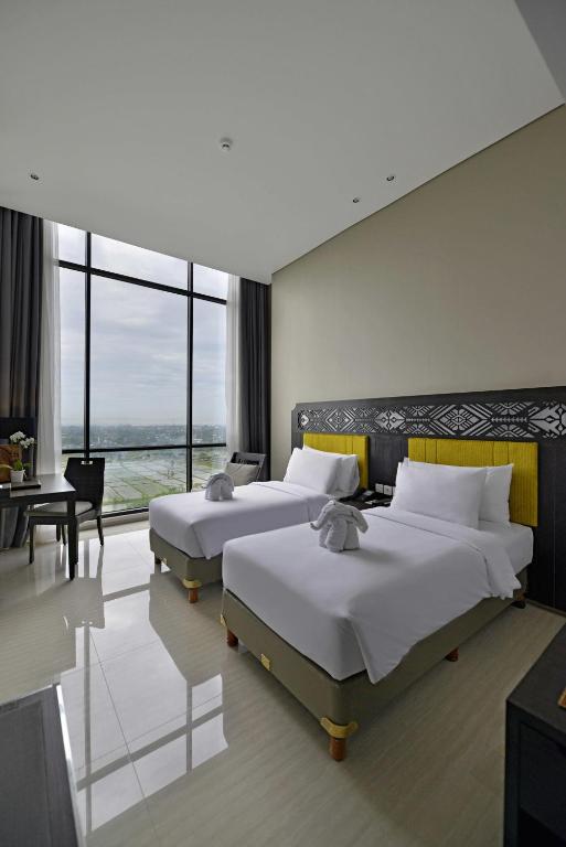 Postel nebo postele na pokoji v ubytování Lombok Astoria Hotel