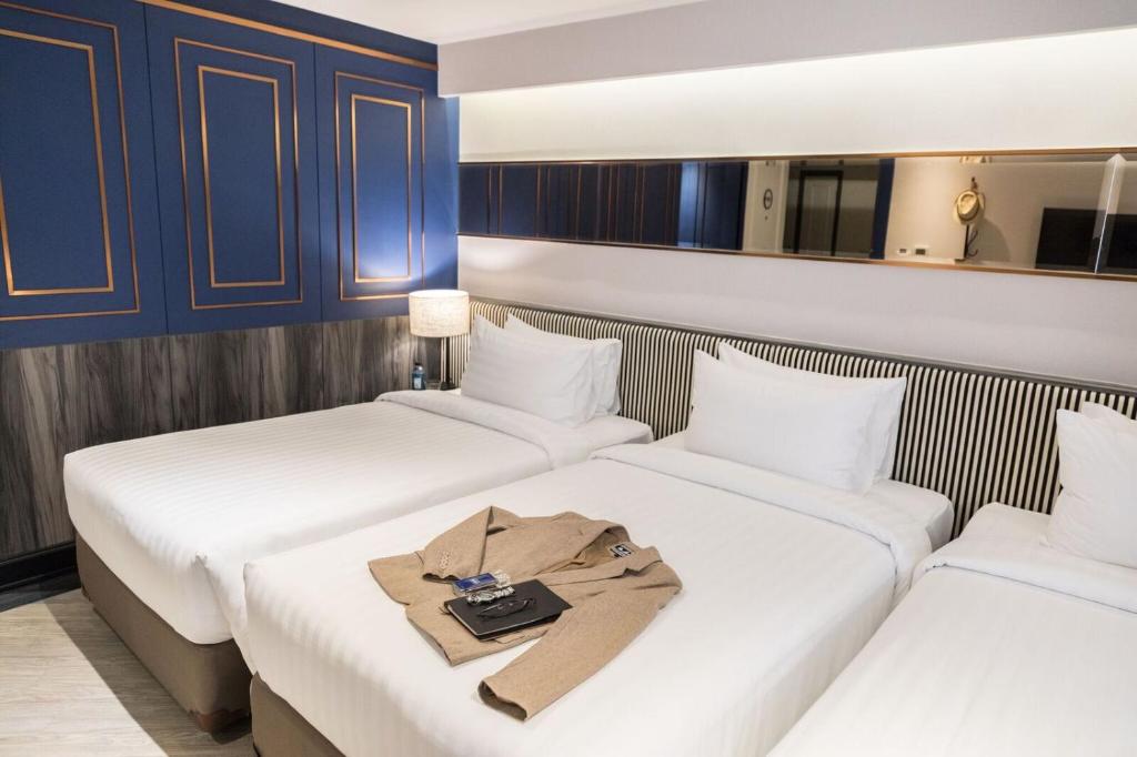 Postel nebo postele na pokoji v ubytování Vince Hotel Pratunam