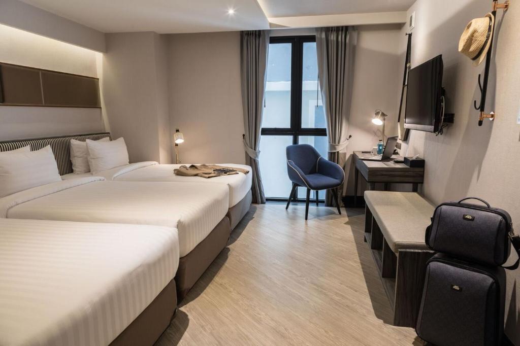 Postel nebo postele na pokoji v ubytování Vince Hotel Pratunam