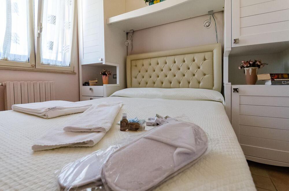 a bedroom with two beds with towels and shoes on them at Sogno D'Epoca 1822 in Monopoli
