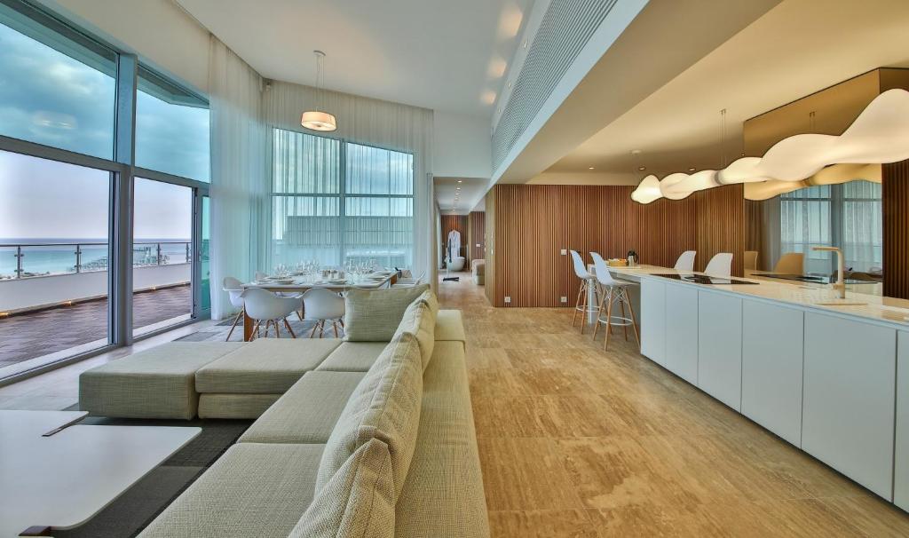a living room with a long couch and a table at Flamingo Grand Hotel & Spa in Albena