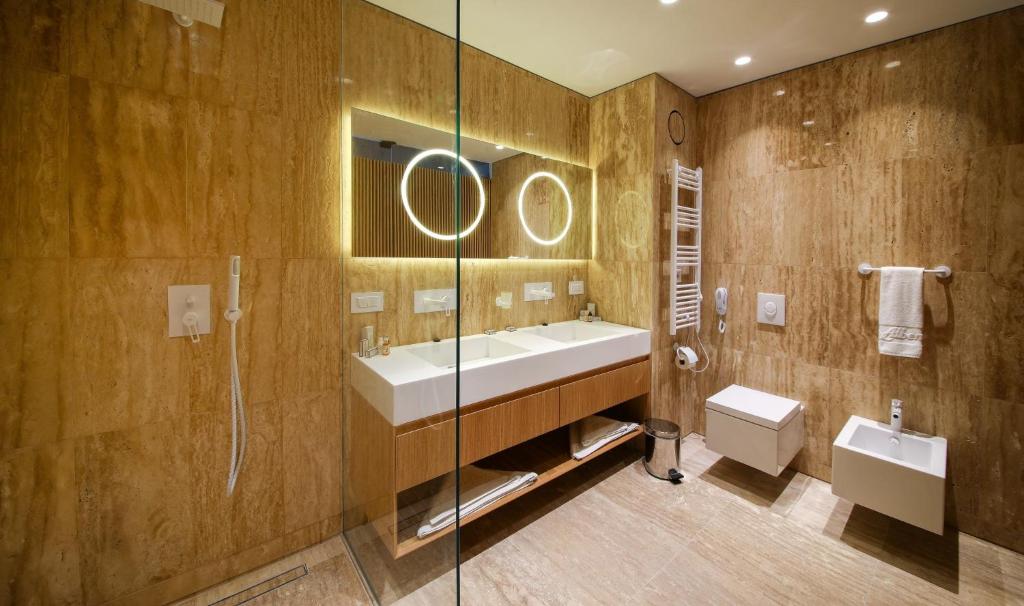 a bathroom with a sink and a shower and a toilet at Flamingo Grand Hotel & Spa in Albena